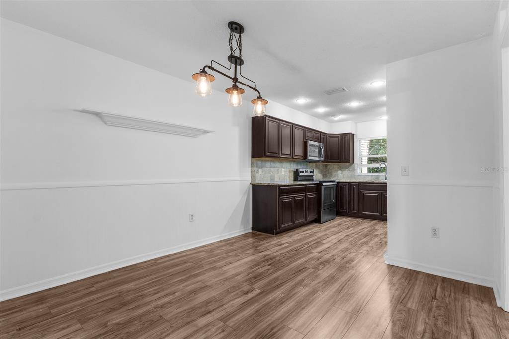 4644 Sawgrass Boulevard New Port Richey, FL 34653 - Photo 10 of 34 a open kitchen with a sink and dishwasher a refrigerator with wooden floor