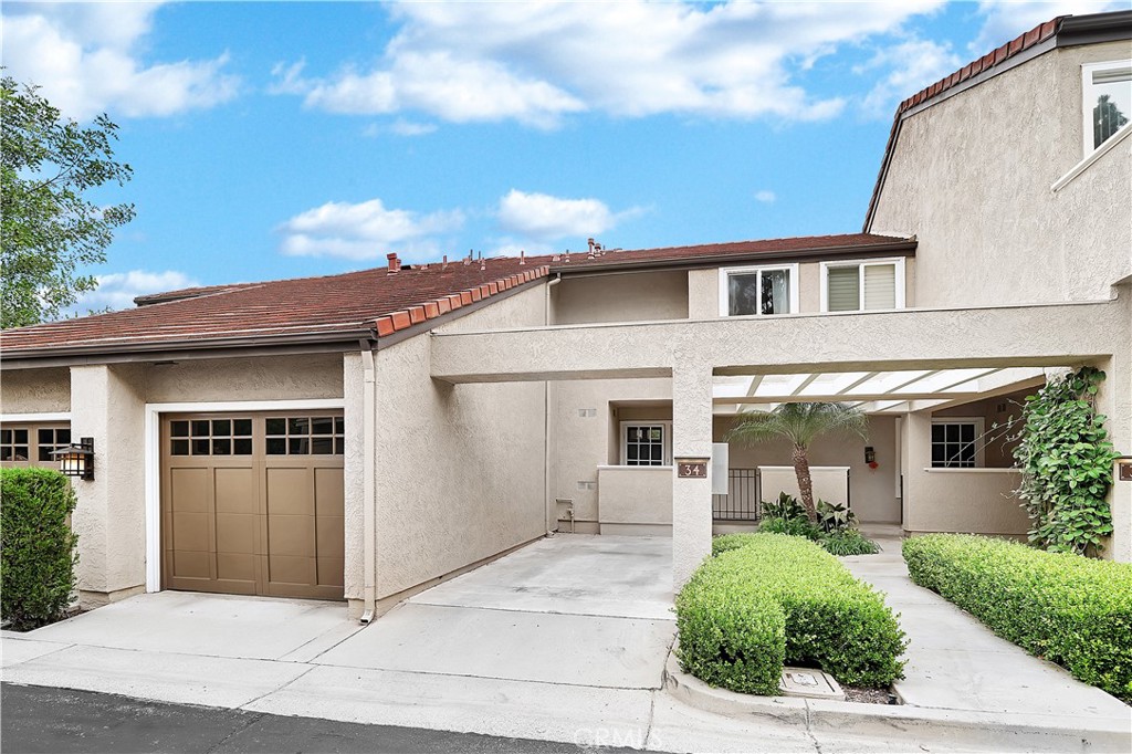 34 Stanford Court, Unit 17 Irvine, CA 92612 - Photo 1 of 25 a view of a white house next to a yard
