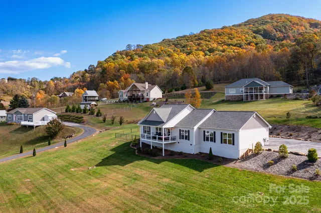 an aerial view of a house with swimming pool garden and patio