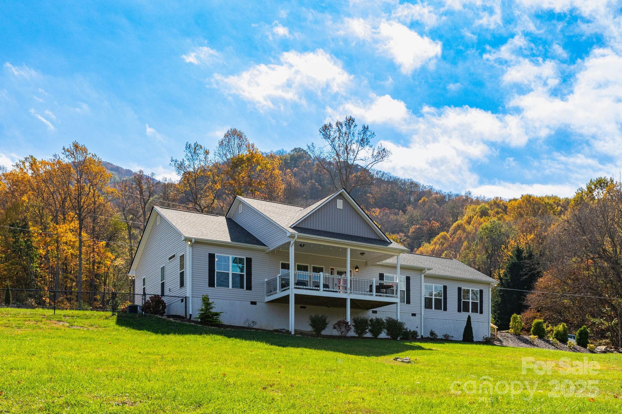 605 Red Bank Road Waynesville, NC 28786 - Photo 28 of 34 a view of a house with a big yard and large trees