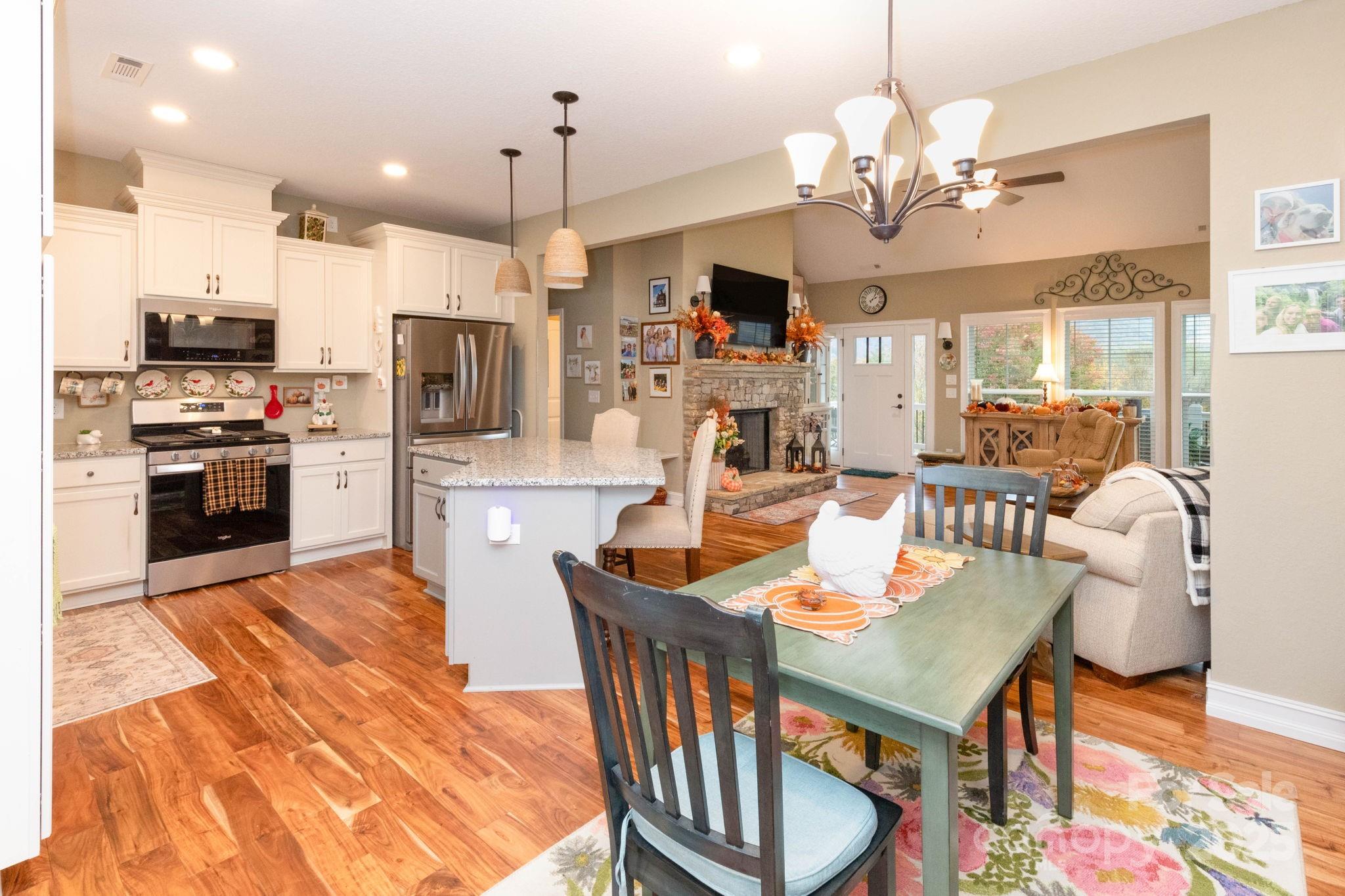 605 Red Bank Road Waynesville, NC 28786 - Photo 6 of 34 a open kitchen with stainless steel appliances kitchen island granite countertop a dining table chairs and a refrigerator