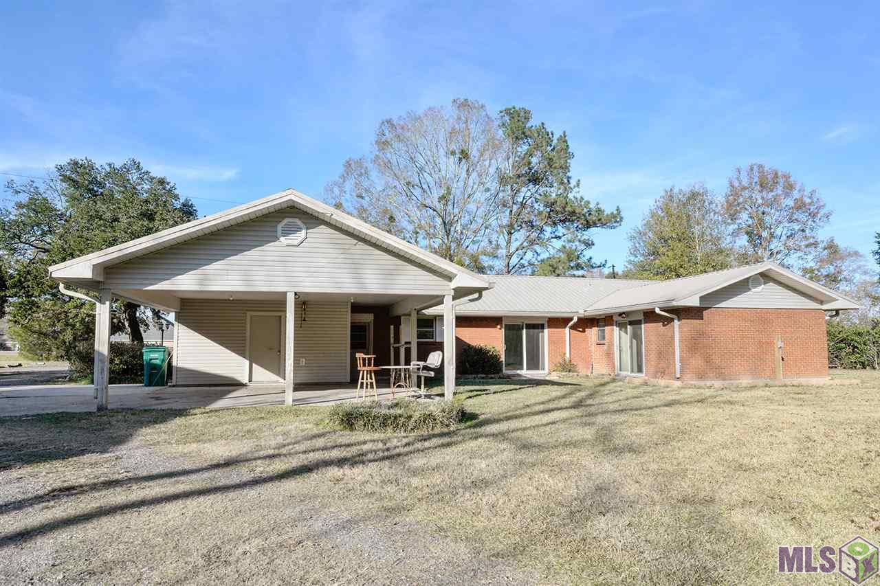 9808 Arnold Road Denham Springs, LA 70726 - Photo 6 of 16 Rear Carport with Adjacent Storage Room