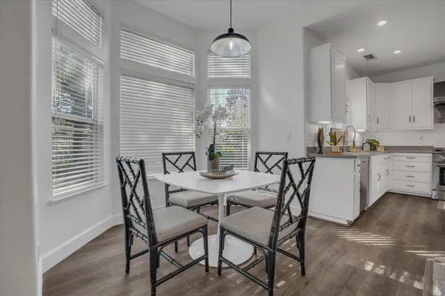 a view of a dining room with furniture and window
