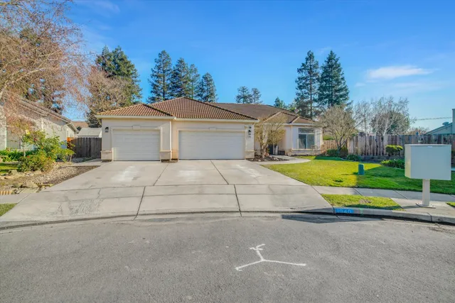a view of house with outdoor space and parking
