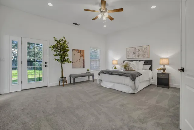 a spacious bedroom with a bed and a chandelier