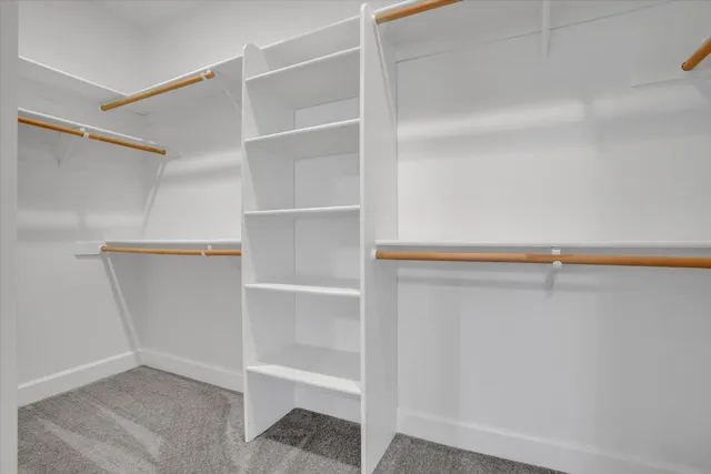 a view of walk in closet with empty racks