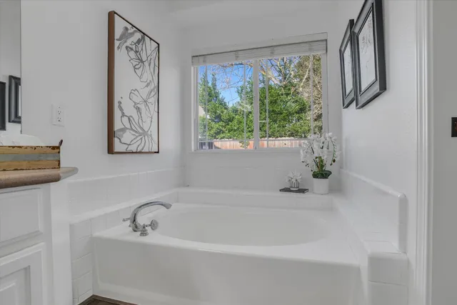a white bath tub sitting next to a window