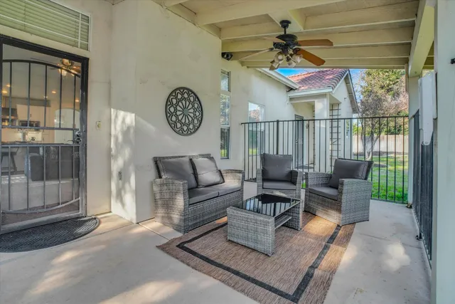 a living room with furniture a fireplace and a window