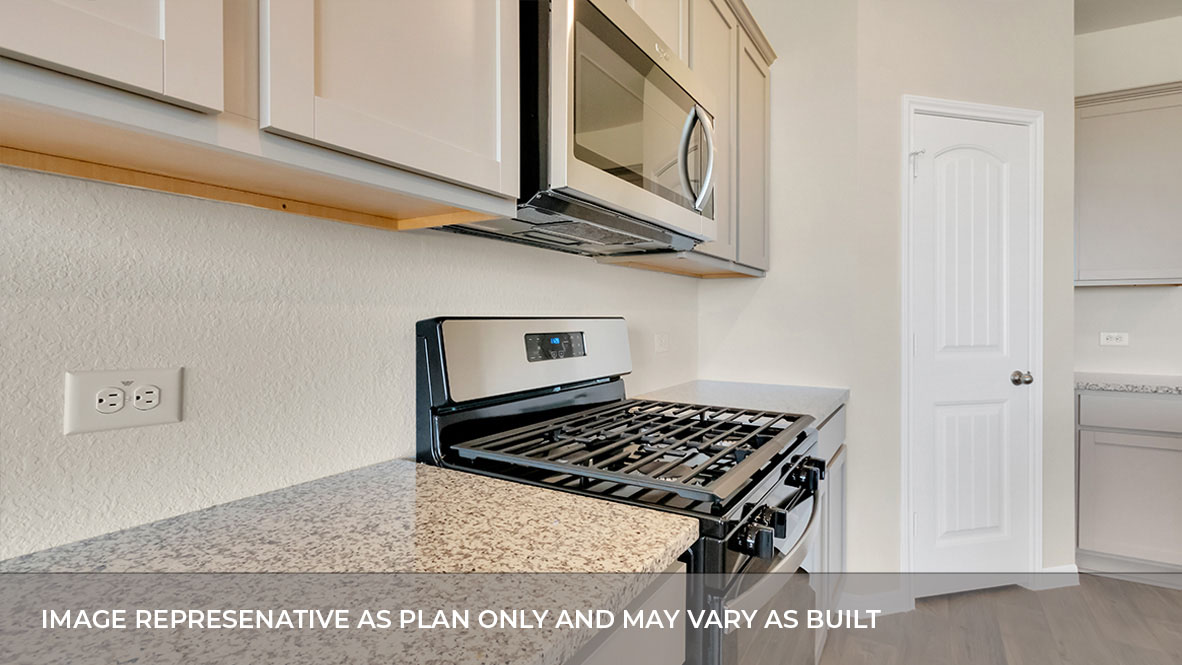193 Balmorhea Street Kyle, TX 78640 - Photo 20 of 32 a kitchen with cabinets and a stove top oven
