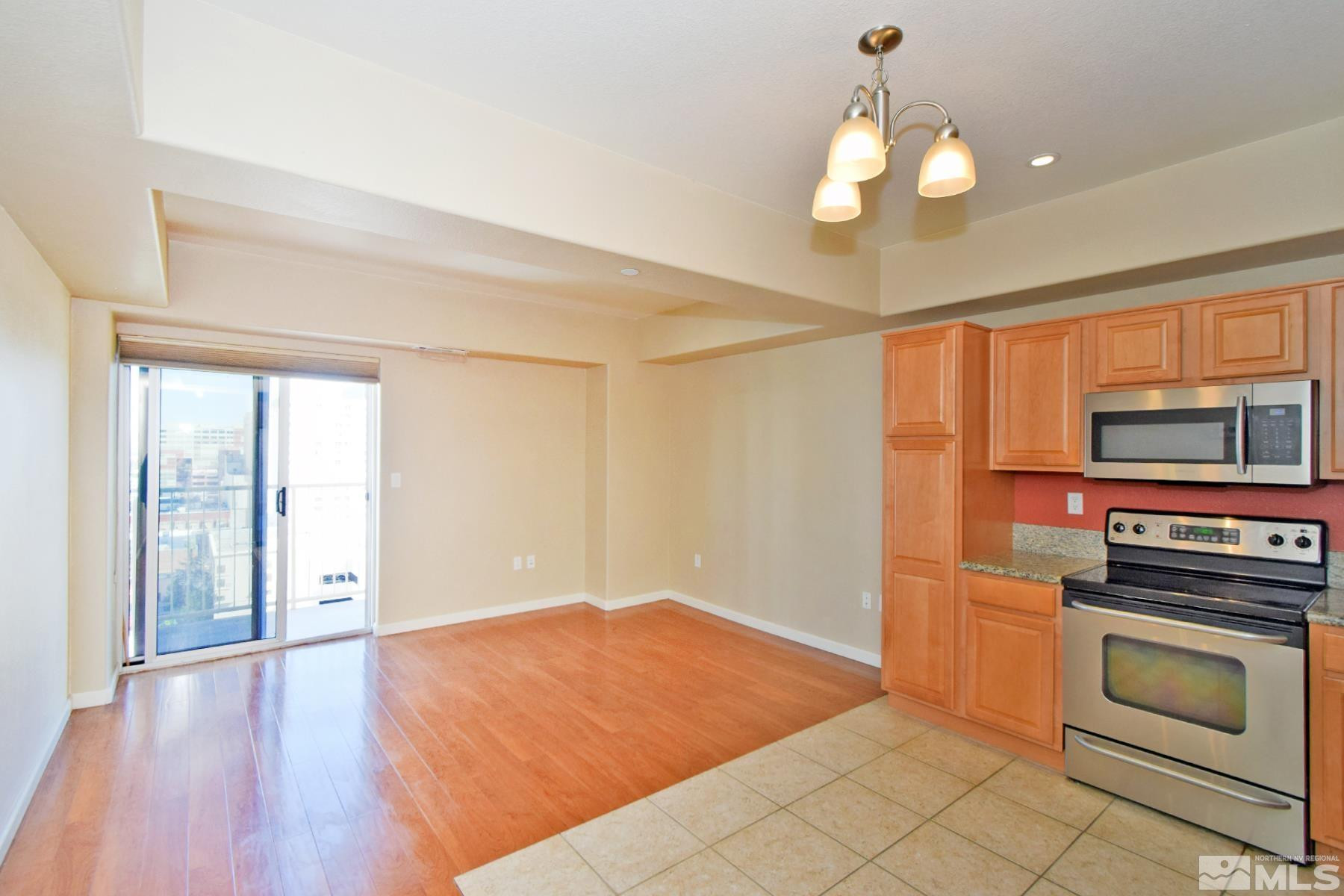 200 West 2nd Street, Unit 1004 Reno, NV 89501 - Photo 5 of 18 a kitchen with stainless steel appliances granite countertop a stove a sink and a refrigerator