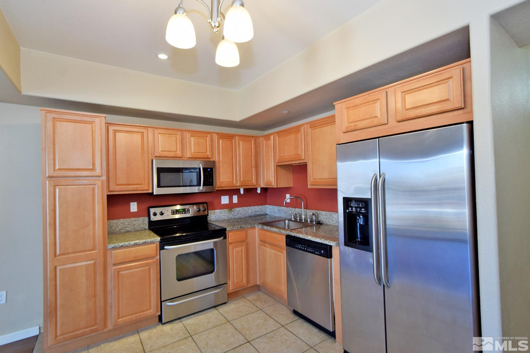 200 West 2nd Street, Unit 1004 Reno, NV 89501 - Photo 6 of 18 a kitchen with a refrigerator stove and microwave