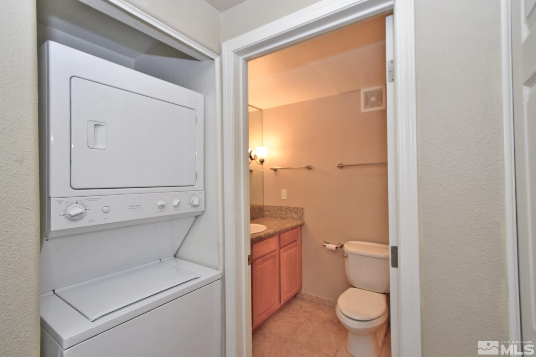 200 West 2nd Street, Unit 1004 Reno, NV 89501 - Photo 8 of 18 a bathroom with a toilet a sink and a mirror