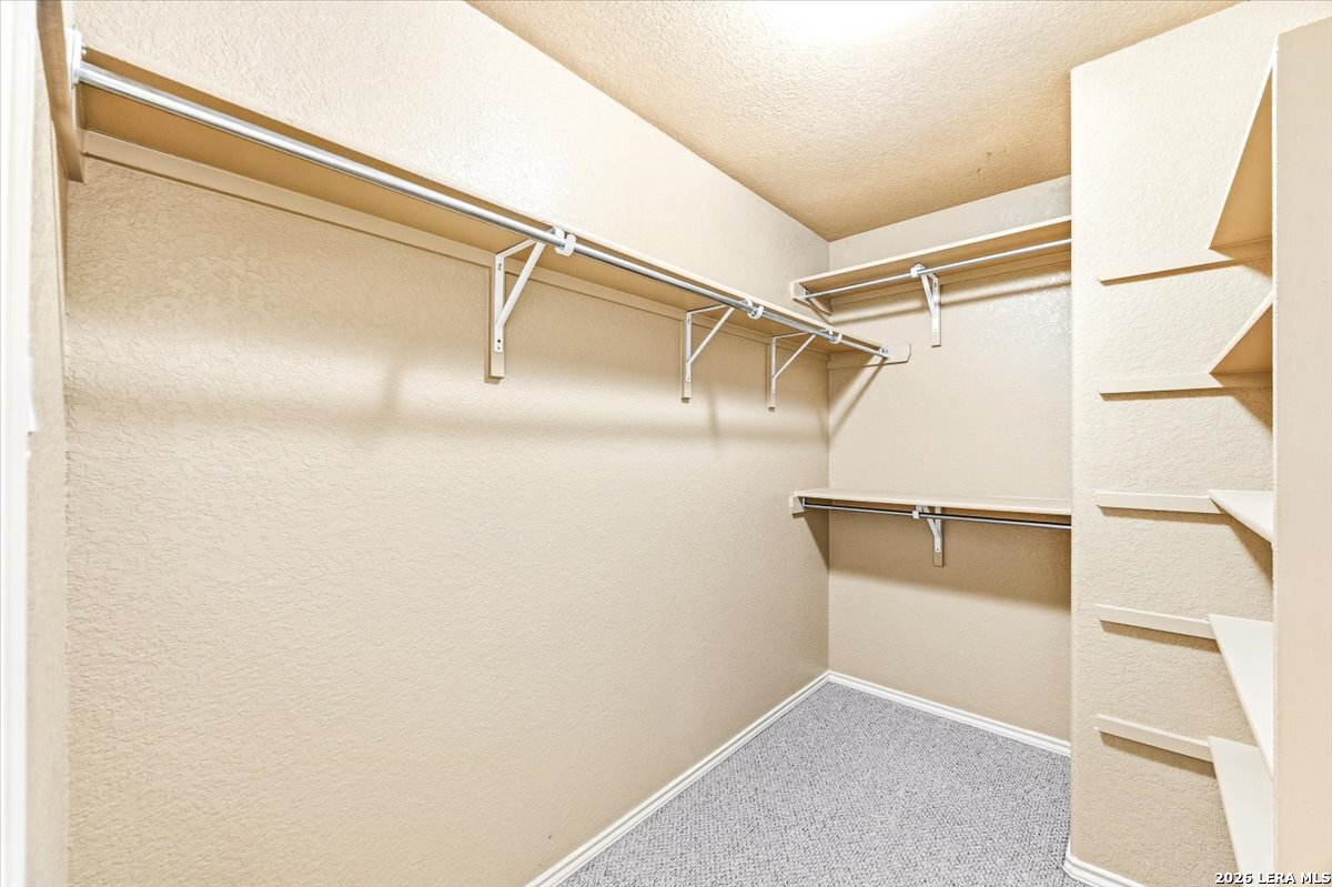 3831 Bacall Way Converse, TX 78109 - Photo 22 of 33 a view of walk in closet with empty racks