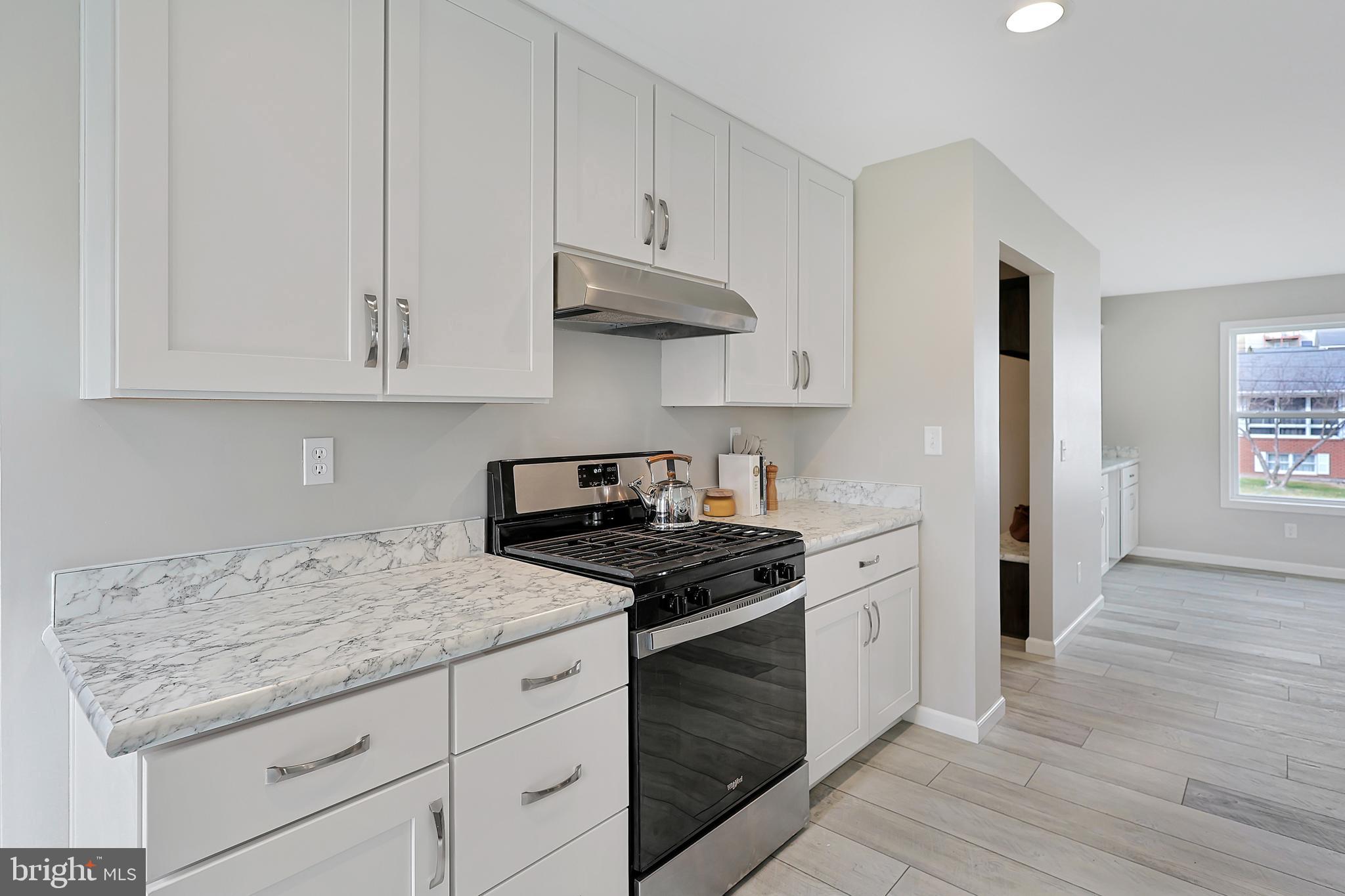 1525 Beacon Street Keyser, WV 26726 - Photo 12 of 59 a kitchen with granite countertop white cabinets and stainless steel appliances