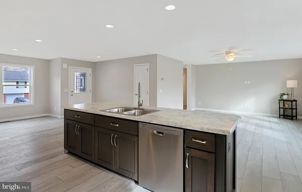 a kitchen with refrigerator cabinets and a sink