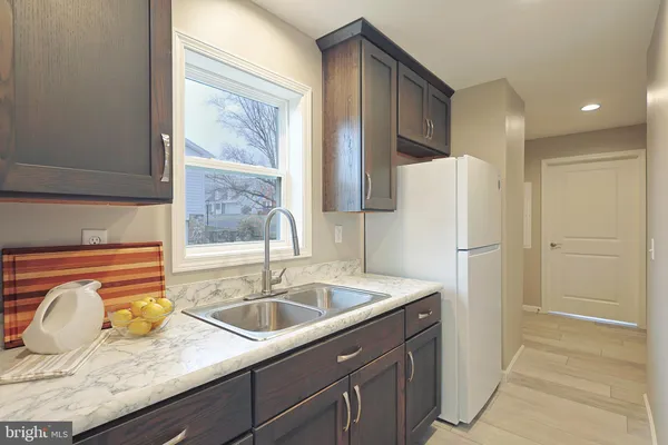 a view of walk in closet with clothes