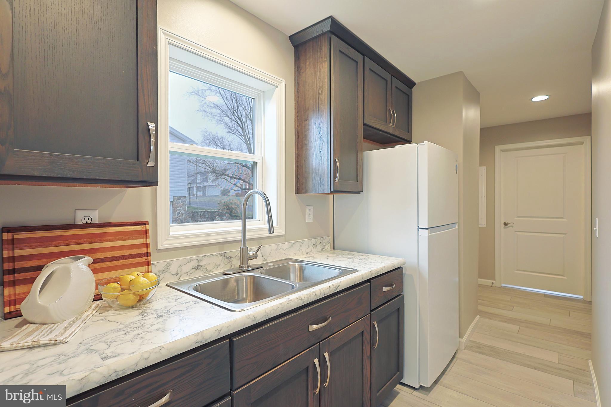 1525 Beacon Street Keyser, WV 26726 - Photo 17 of 67 a kitchen with refrigerator cabinets and a sink