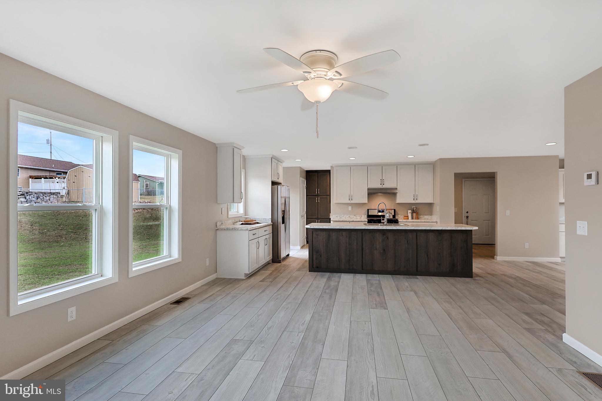 1525 Beacon Street Keyser, WV 26726 - Photo 19 of 59 a living room with stainless steel appliances kitchen island wooden floors and view living room
