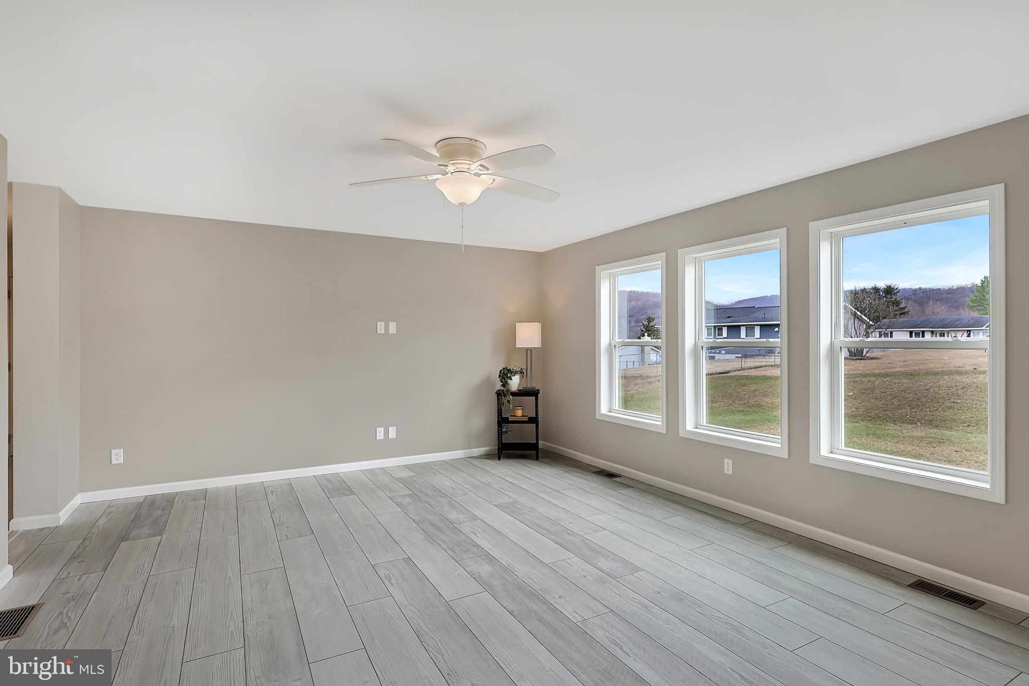 1525 Beacon Street Keyser, WV 26726 - Photo 23 of 67 a view of an empty room with a window and wooden floor