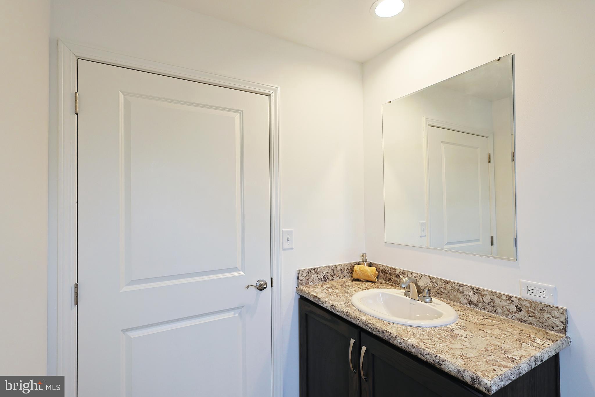 1525 Beacon Street Keyser, WV 26726 - Photo 28 of 59 a bathroom with a granite countertop sink and a mirror