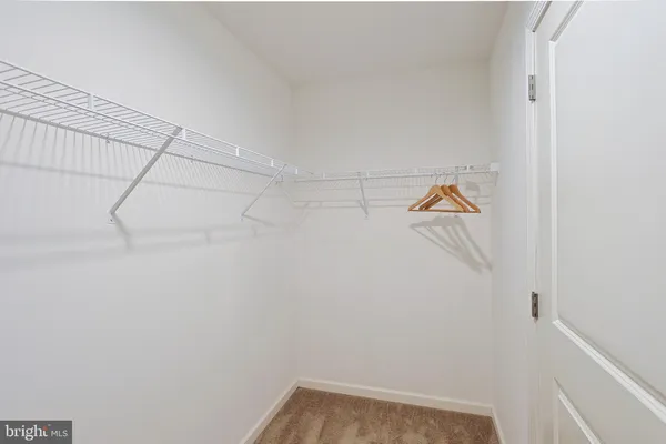 a bathroom with a granite countertop sink a toilet a mirror and bathtub