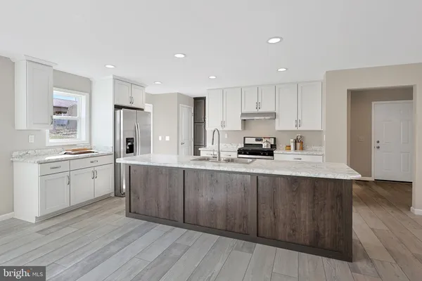 a stove top oven sitting inside of a kitchen
