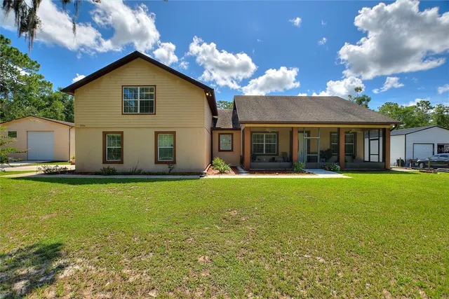 a view of a house with a backyard