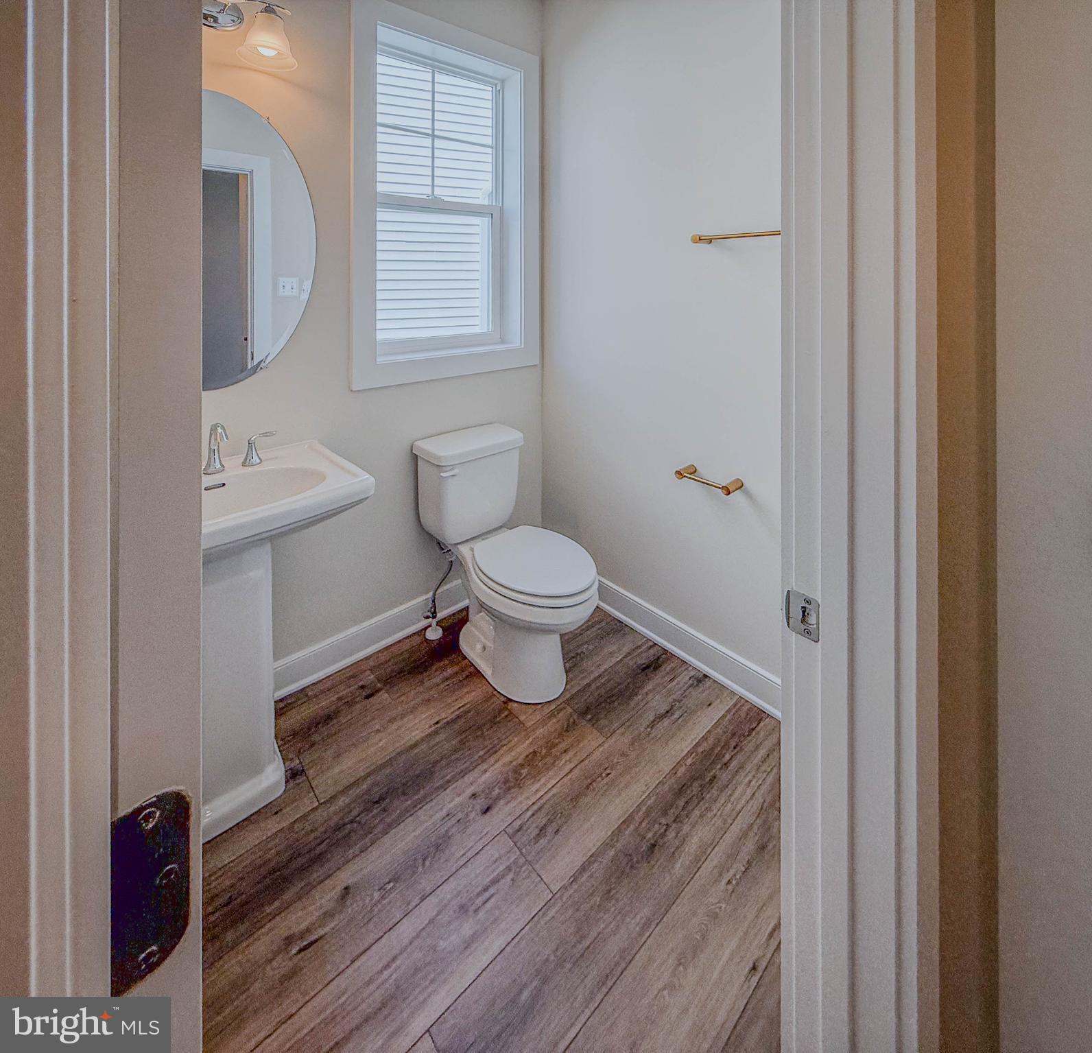8785 Helleber Spring Circle Frederick, MD 21701 - Photo 14 of 49 a bathroom with a toilet a sink and mirror