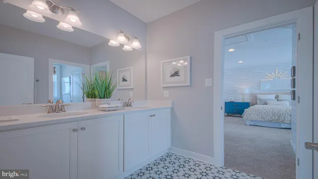 a bathroom with a sink a light fixture and a mirror