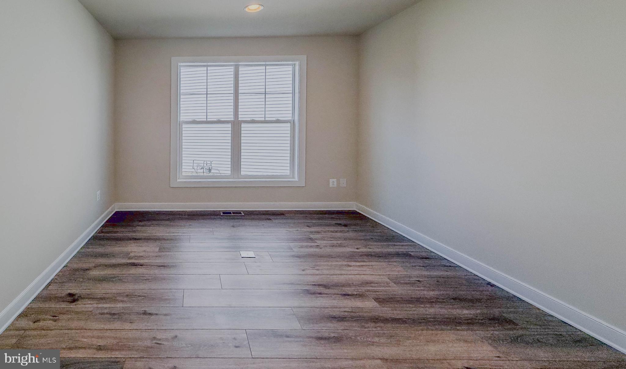 8785 Helleber Spring Circle Frederick, MD 21701 - Photo 17 of 49 an empty room with wooden floor and windows