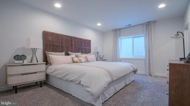 a spacious bedroom with a bed and a window