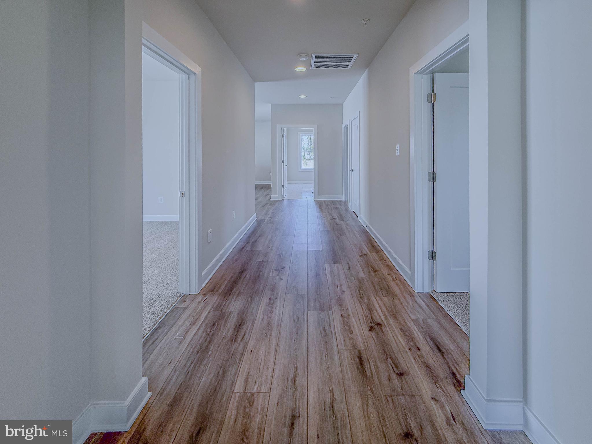 8785 Helleber Spring Circle Frederick, MD 21701 - Photo 27 of 49 a view of a hallway with wooden floor