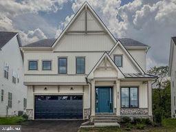 8785 Helleber Spring Circle Frederick, MD 21701 - Photo 3 of 22 a front view of a house with garage