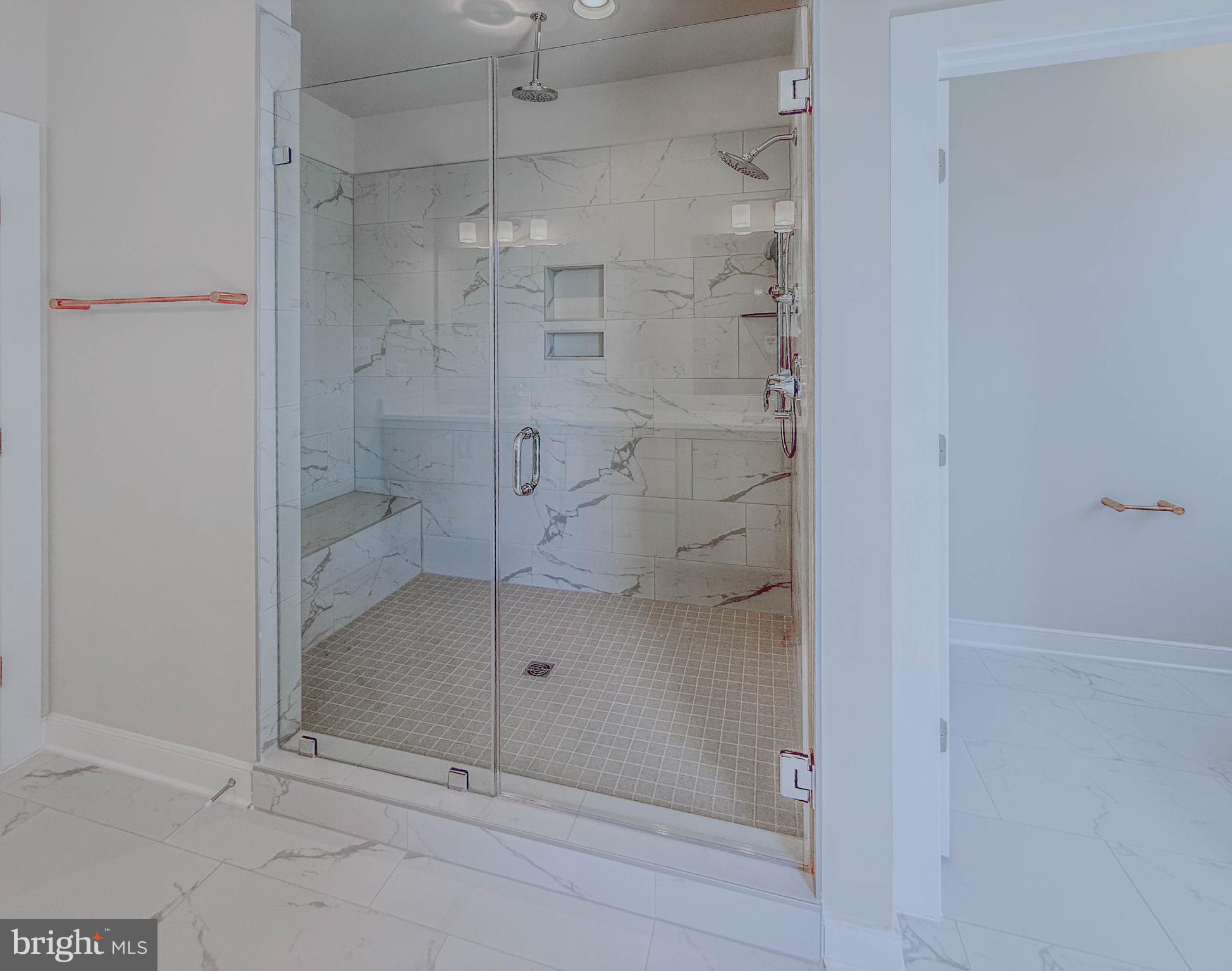 8785 Helleber Spring Circle Frederick, MD 21701 - Photo 34 of 49 a bathroom with a glass shower door
