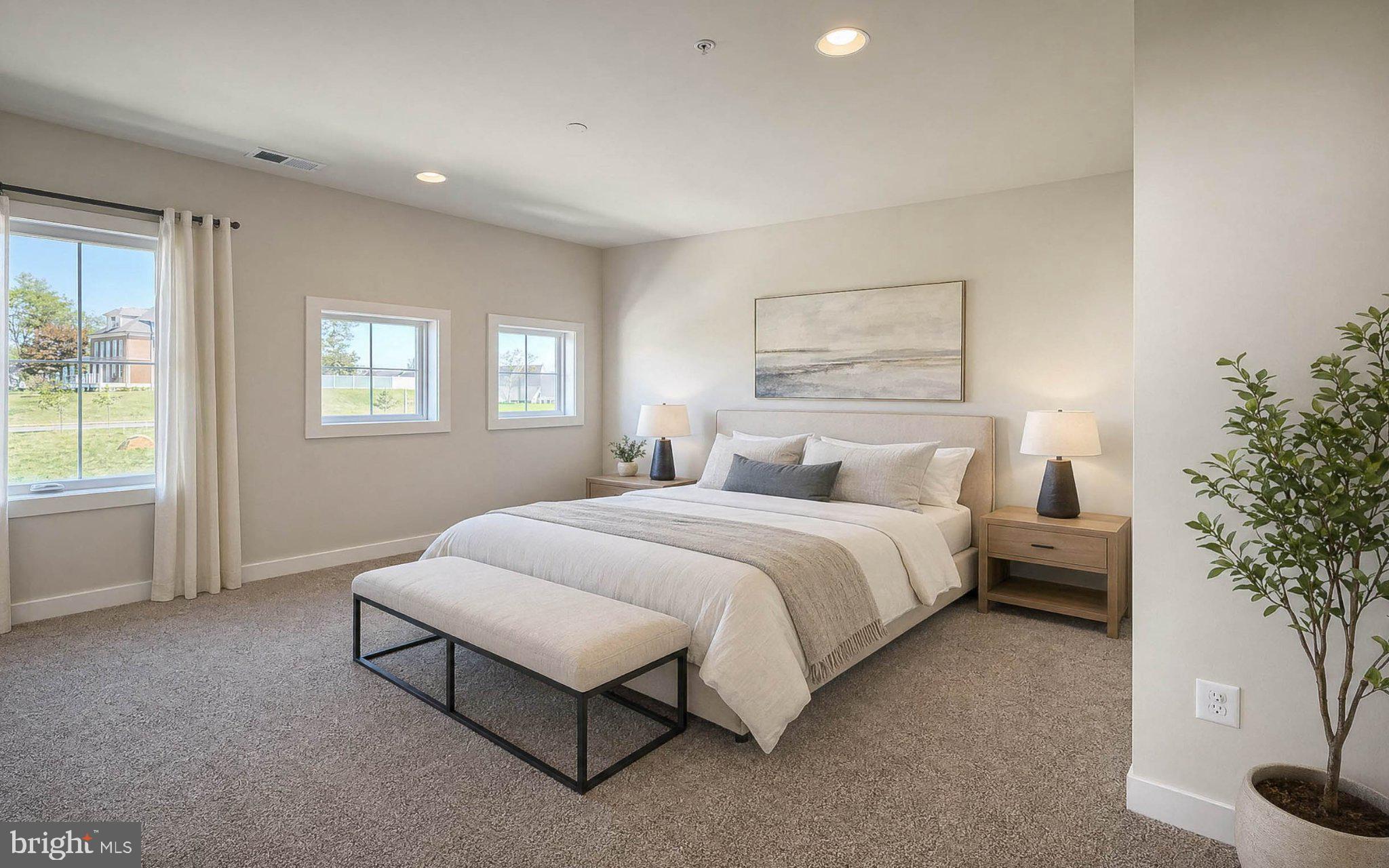 8785 Helleber Spring Circle Frederick, MD 21701 - Photo 35 of 49 a spacious bedroom with a bed and a potted plant