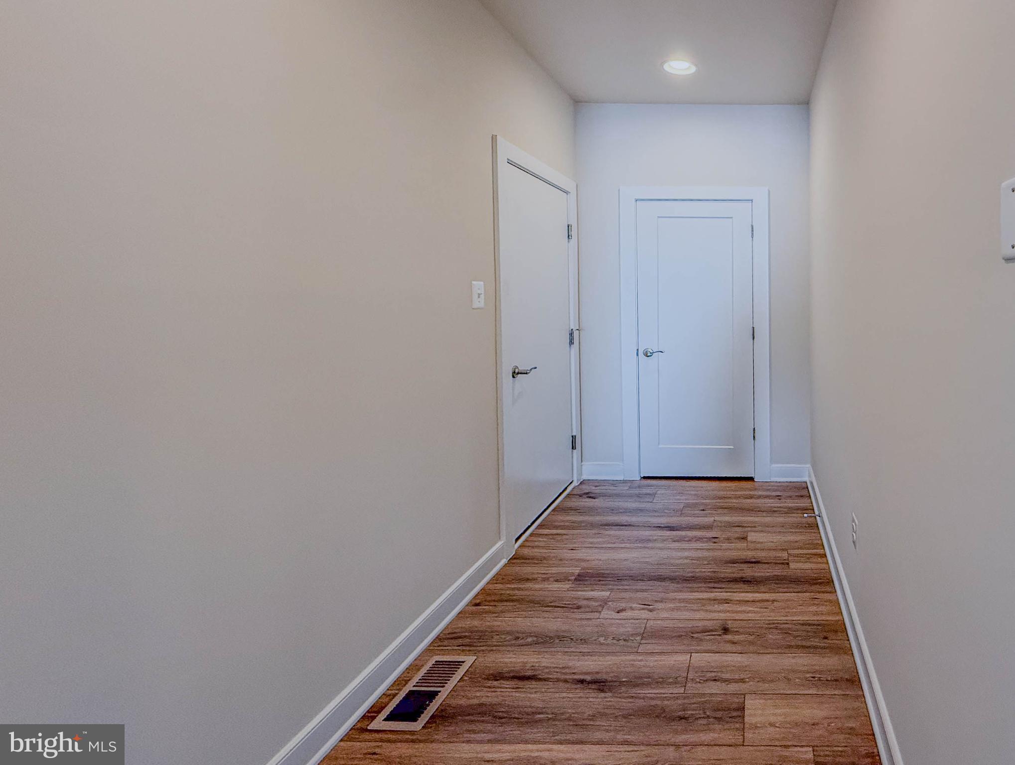 8785 Helleber Spring Circle Frederick, MD 21701 - Photo 48 of 49 a view of a hallway with wooden floor