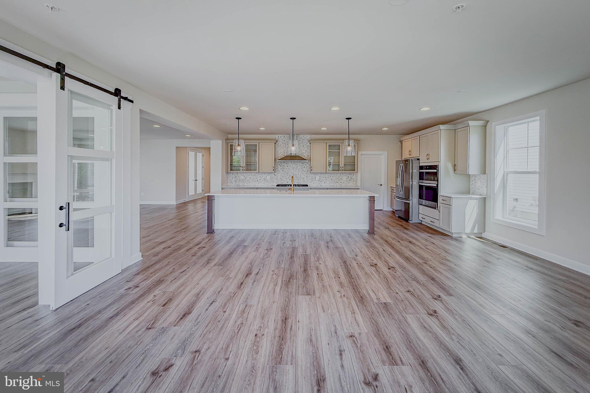 8785 Helleber Spring Circle Frederick, MD 21701 - Photo 5 of 49 a view of kitchen with cabinets wooden floor and stainless steel appliances
