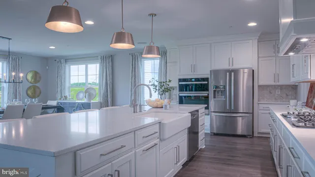 a kitchen with refrigerator and cabinets