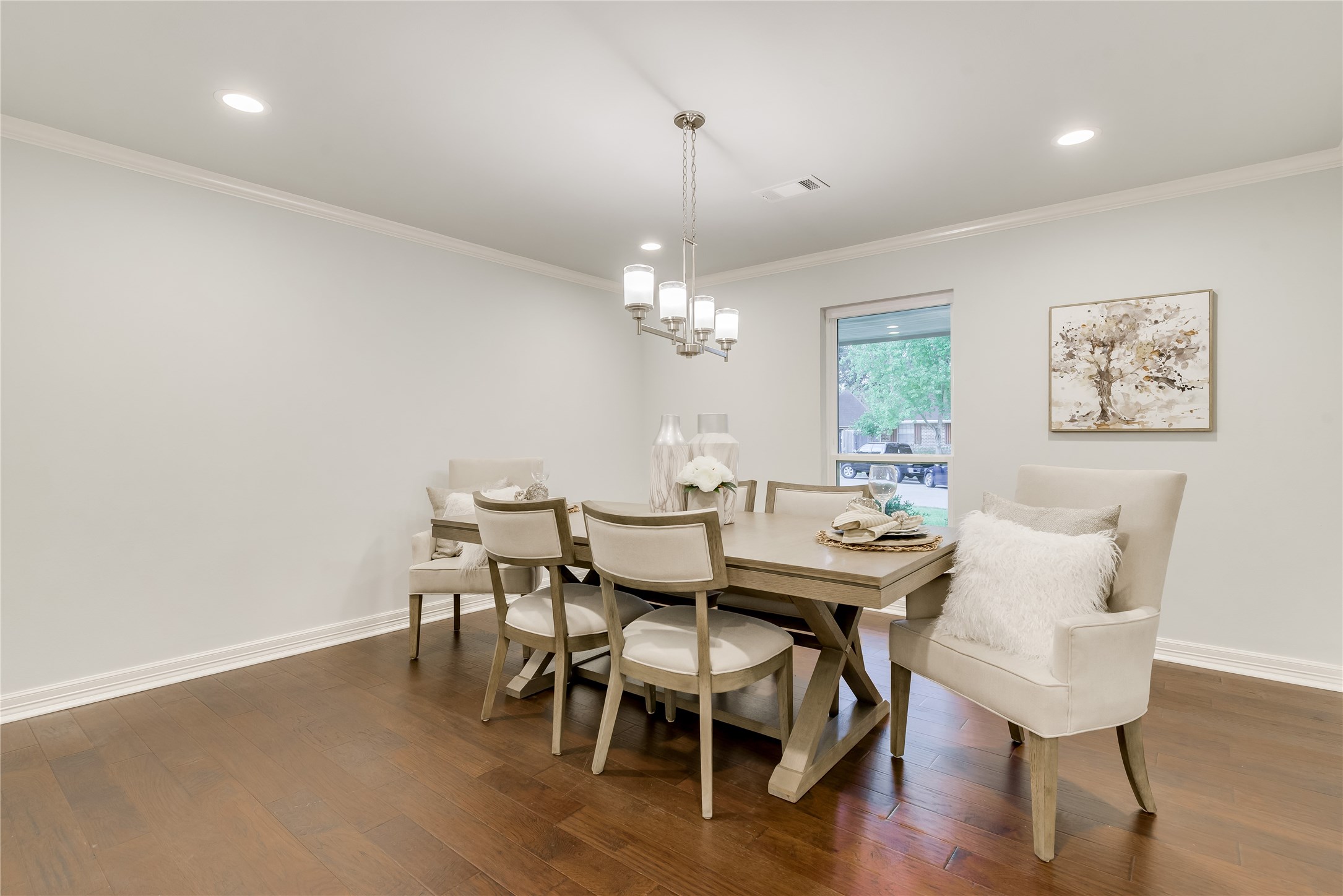 1010 Thornton Road Houston, TX 77018 - Photo 14 of 27 Stylish dining room with hardwood floors and neutral walls, featuring a modern chandelier and a large window for natural light.