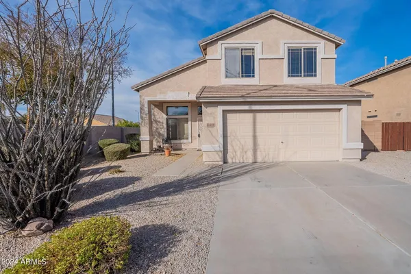 a view of a house with a yard and garage