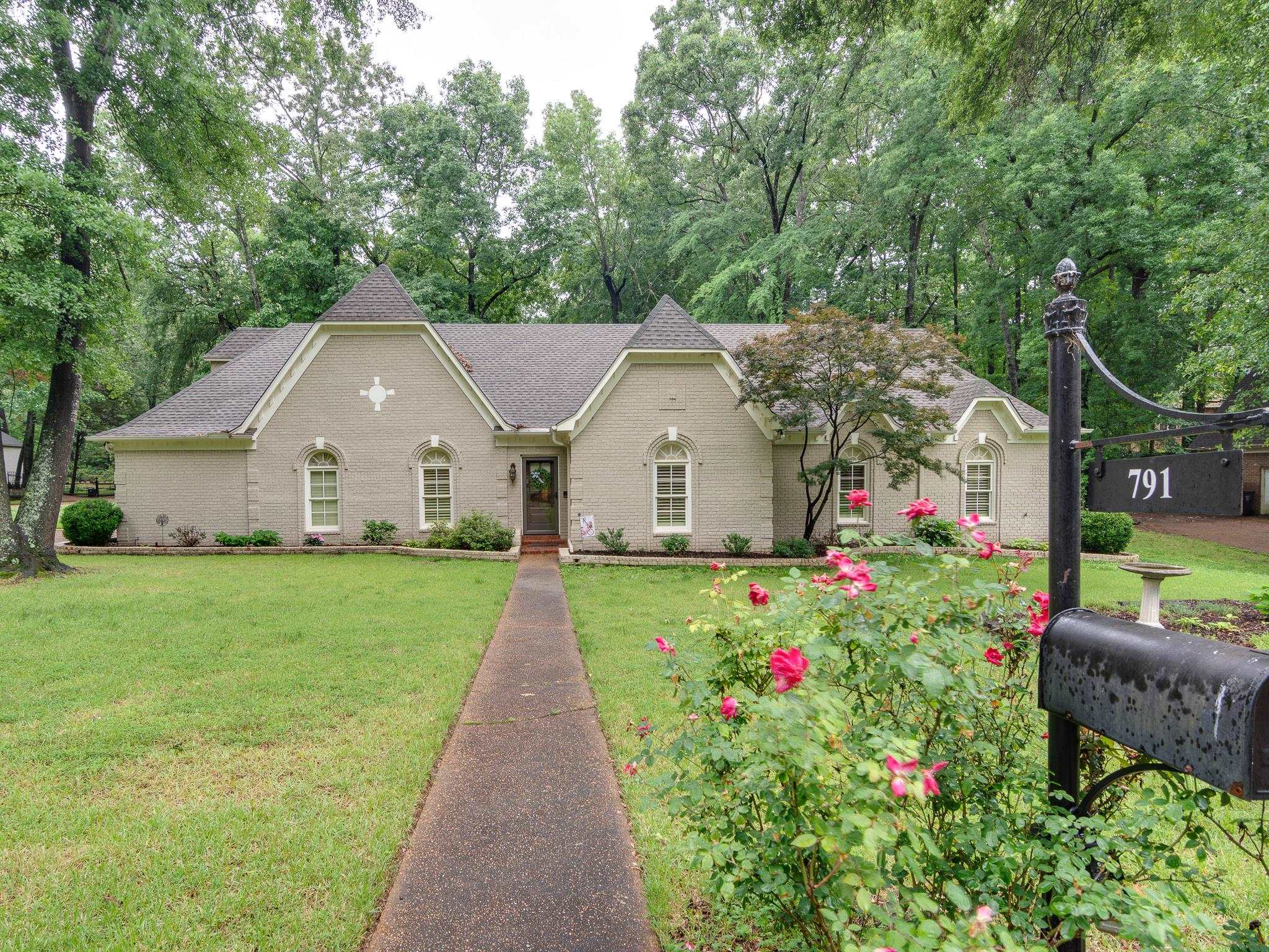 791 North Tree Drive Collierville, TN 38017 - Photo 1 of 27 Traditional-style residence with a neutral-toned brick exterior and a dark shingle roof