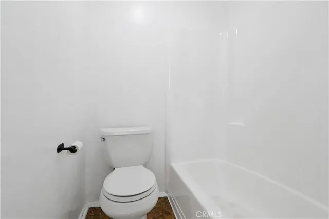 a white toilet sitting next to a sink