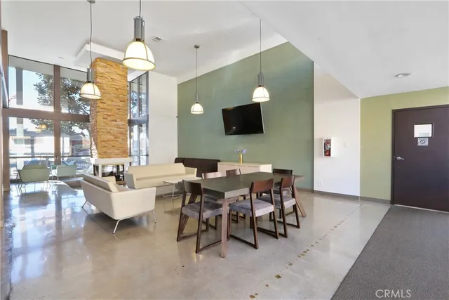 a view of a dining room with furniture and a floor to ceiling window