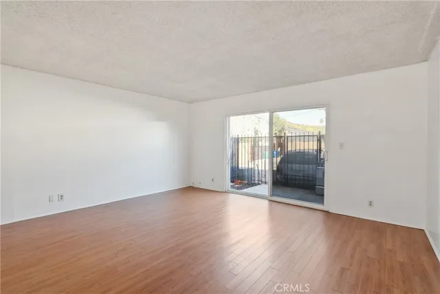 a view of an empty room and glass door
