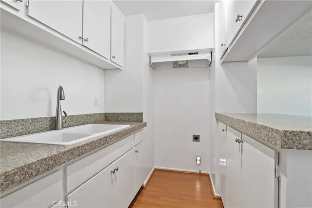 a kitchen with a sink and cabinets