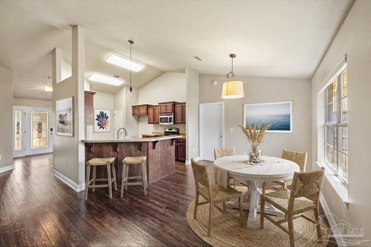 4015 Berry Circle Pace, FL 32571 - Photo 18 of 48 a view of a dining room with furniture and wooden floor