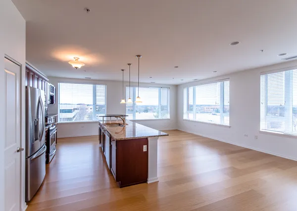 a kitchen with stainless steel appliances granite countertop a stove microwave and sink