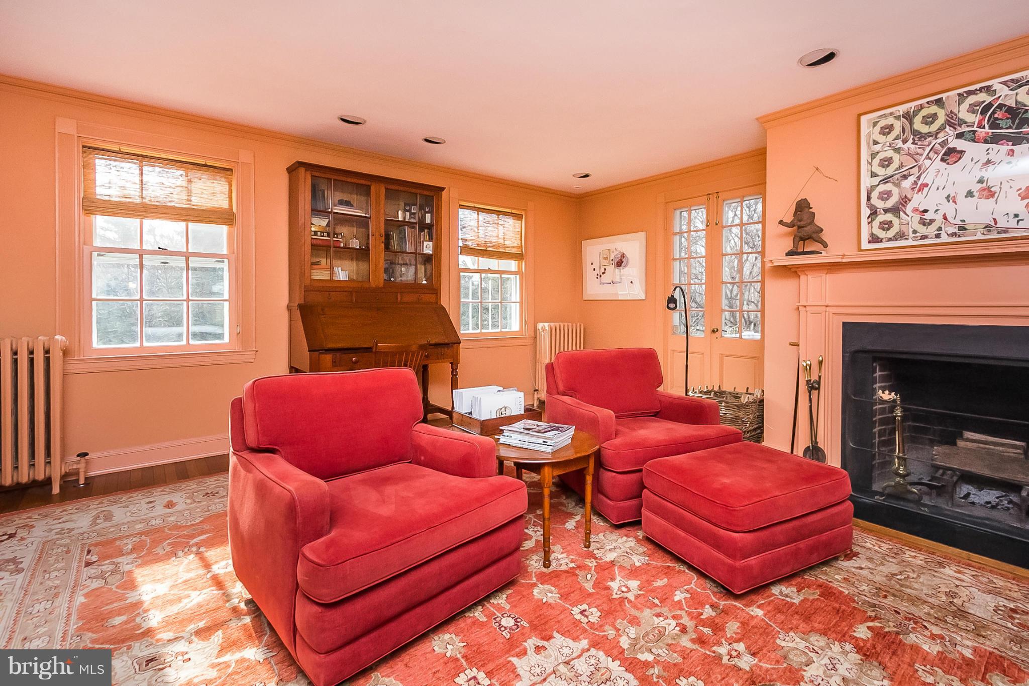 921 Bellemore Road Baltimore, MD 21210 - Photo 16 of 26 a living room with furniture a fireplace and wooden floor