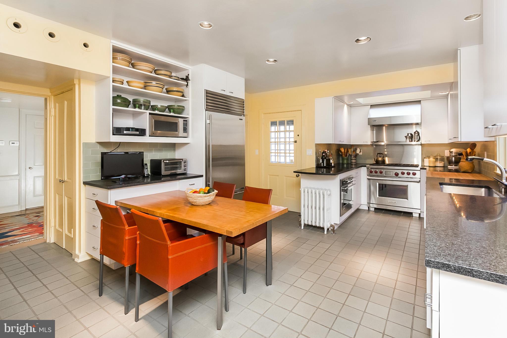 921 Bellemore Road Baltimore, MD 21210 - Photo 7 of 26 a kitchen with stainless steel appliances granite countertop a stove top oven a sink dishwasher and cabinets with wooden floor