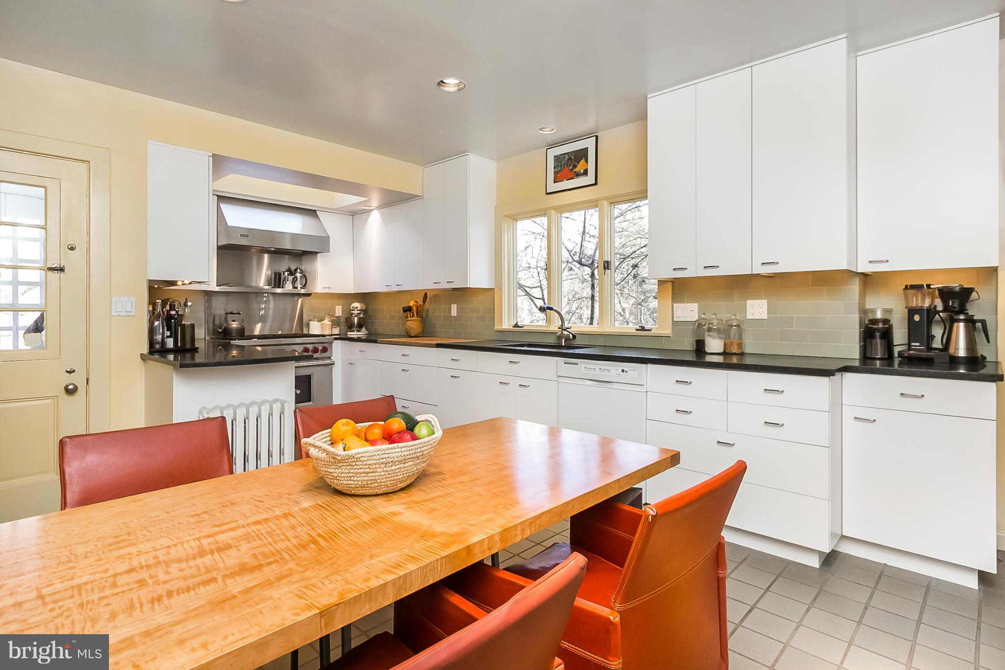 921 Bellemore Road Baltimore, MD 21210 - Photo 8 of 26 a kitchen with stainless steel appliances kitchen island granite countertop a dining table chairs and sink